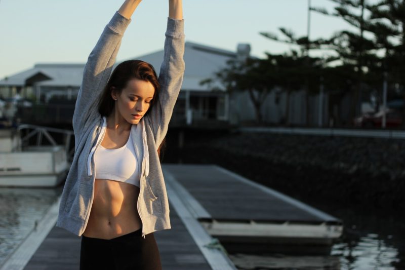 woman with abs stretching