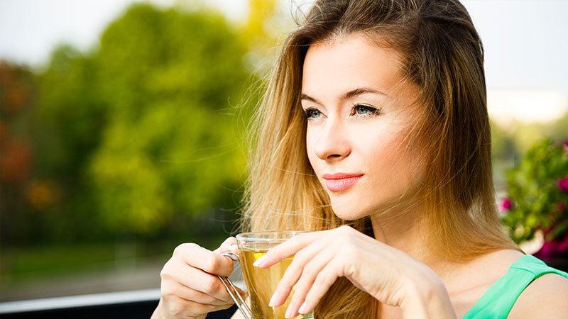 Woman drinking green tea for weight loss