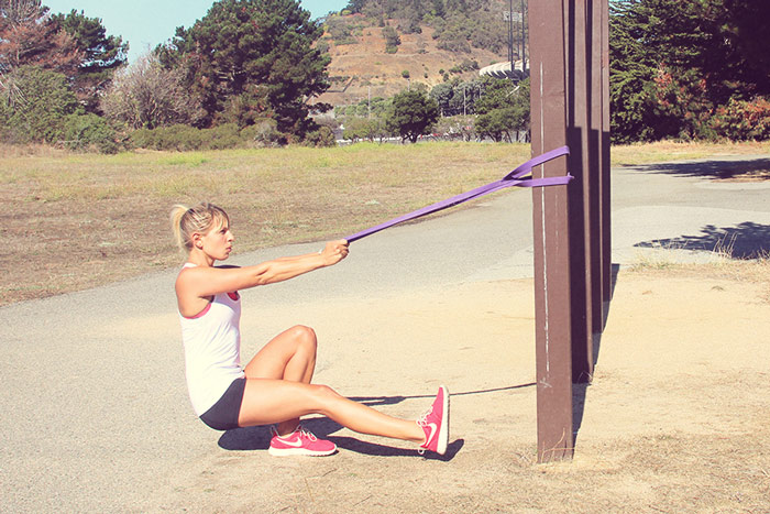 woman performs assisted pistol squat