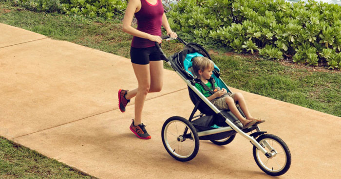 woman pushing jogging stroller