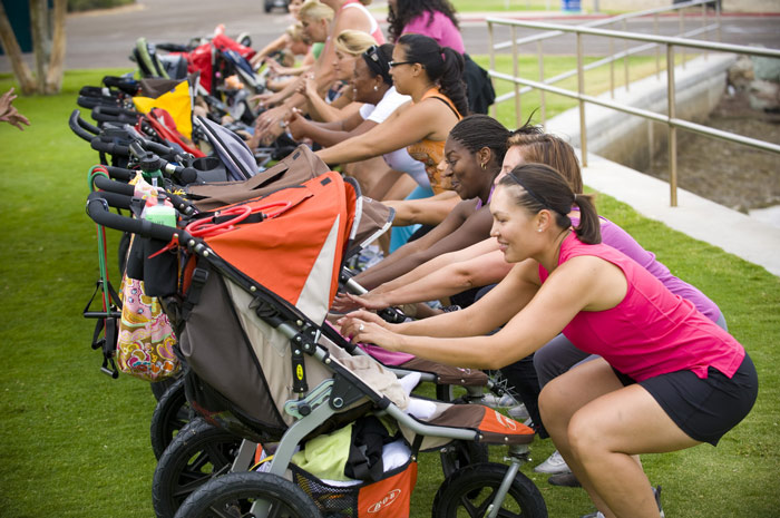 moms interact with babies in jogging stroller