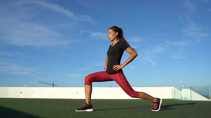 Woman performs forward lunge