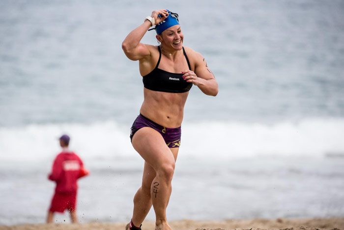 Kara Saunders (Webb) runs across sand during CrossFit games