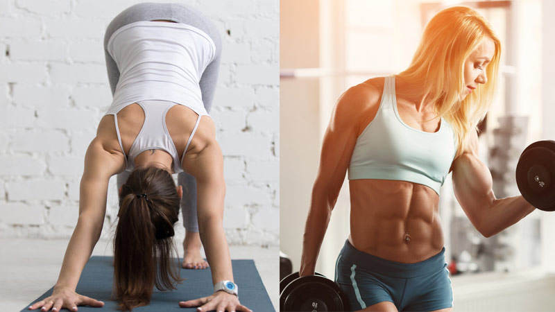 woman downward dogs next to female bodybuilder bicep curling