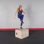woman performs box step up with knee raise