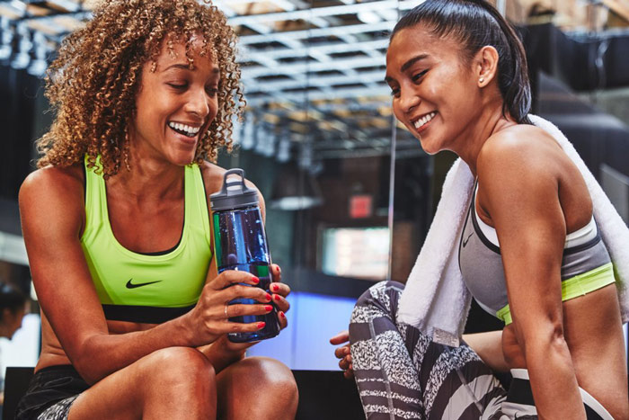 two fitness females smiling as perfect workout partners