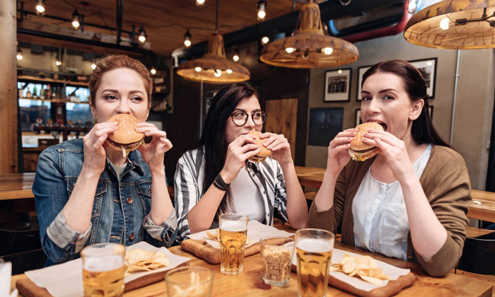 group of women enjoying a meal as part of IIFYM flexible diet