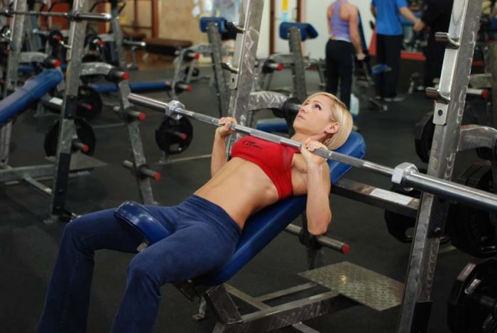 Woman at the bottom of an incline bench press