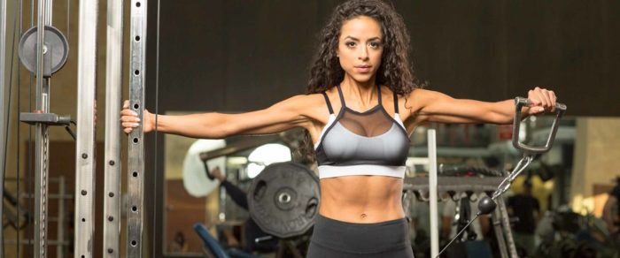 Woman performing a cable raise as part of the best shoulder workout