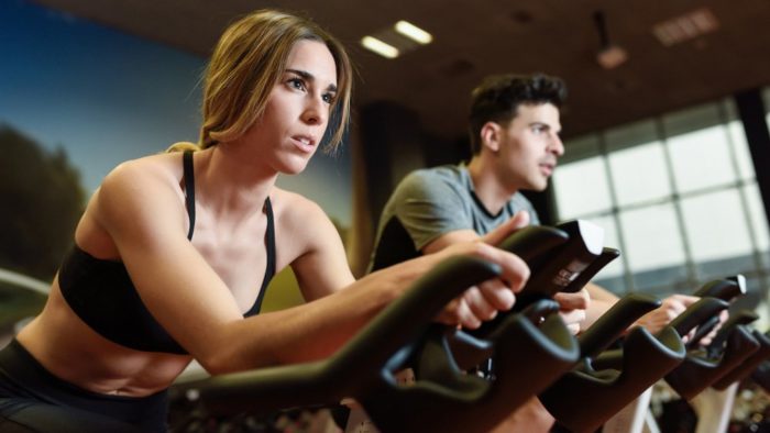 Woman on a static bike performing an LISS cycling workout