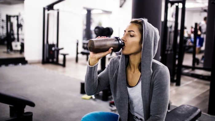 woman drinking creatine shake