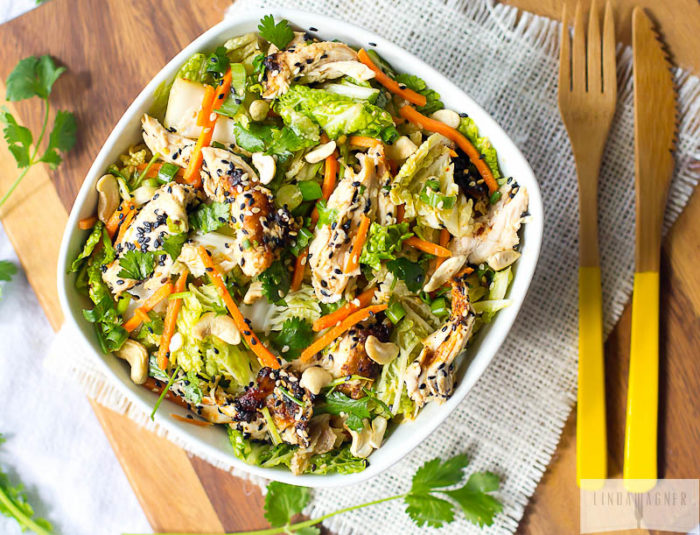 A brightly colored bowl of chicken salad on a table