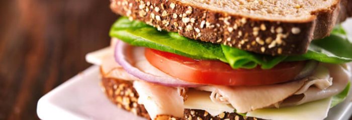 a close up of a healthy turkey sandwich as a lunch meal