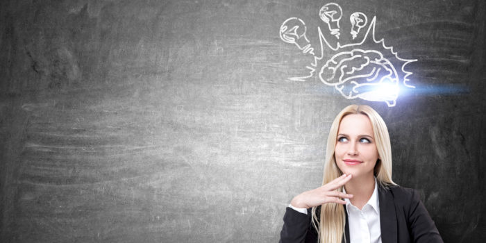 Woman infront of a chalk board with a brain drawn on it