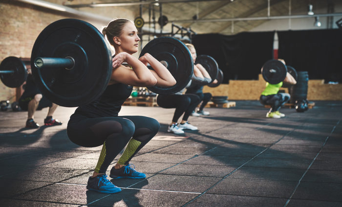 woman doing thrusters as hiit exercises