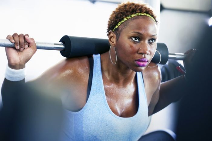 woman doing a squat in a strength training workout