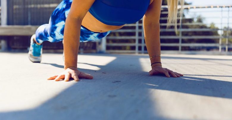 Woman performing push up strength training without weights