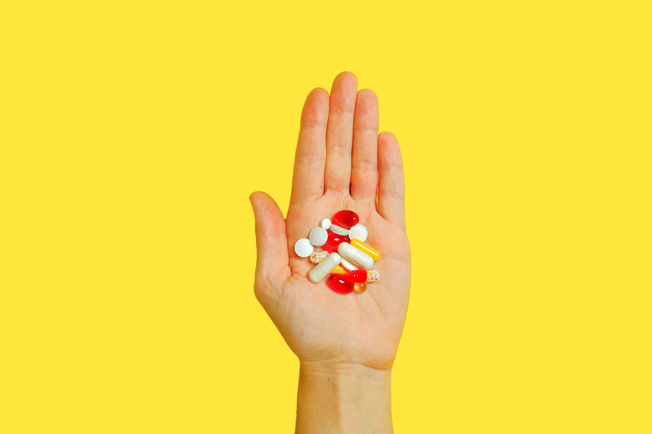 Collection of women's multivitamins in a persons hand